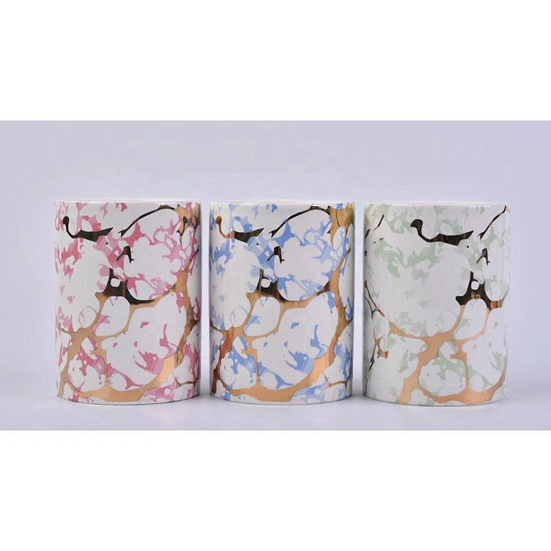 straight ceramic candle jars with gold marble patterns