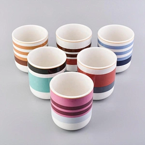 glossy ceramic candle jars with colorful stripes
