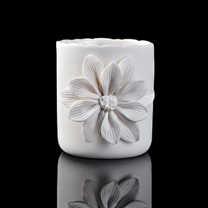 white ceramic candle vessel with flower