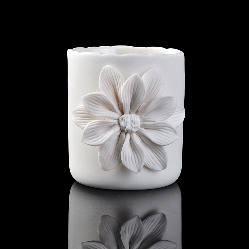 white ceramic candle vessel with flower