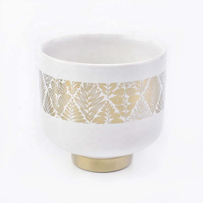 white ceramic candle jars with gold designs