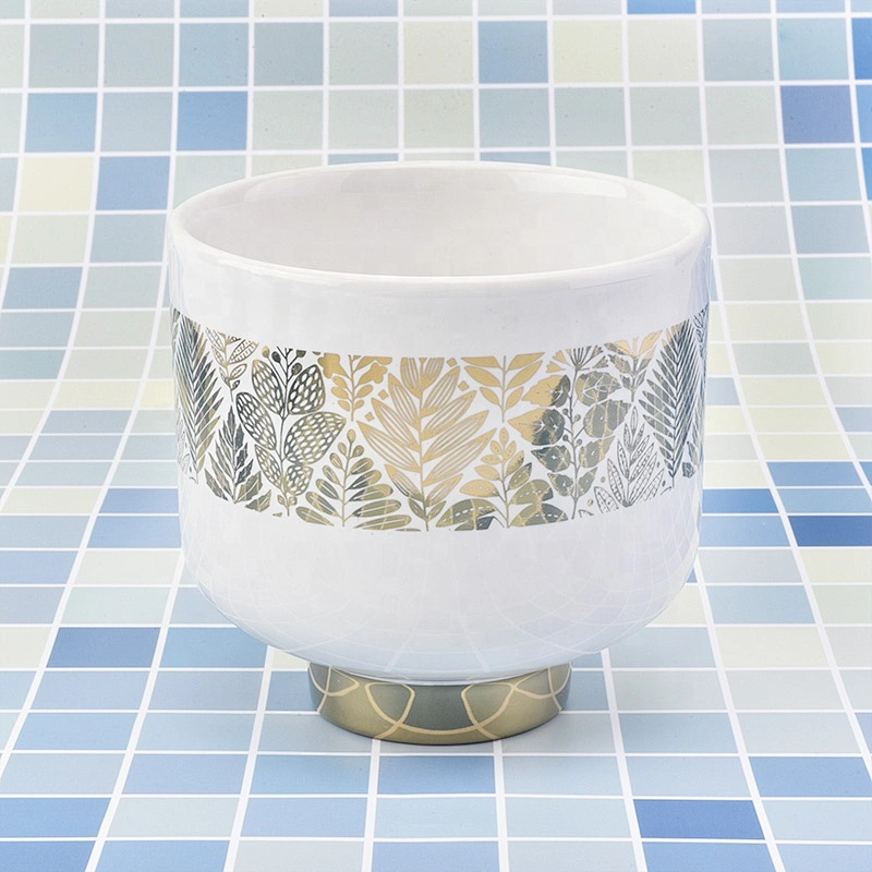 white ceramic candle jars with gold designs