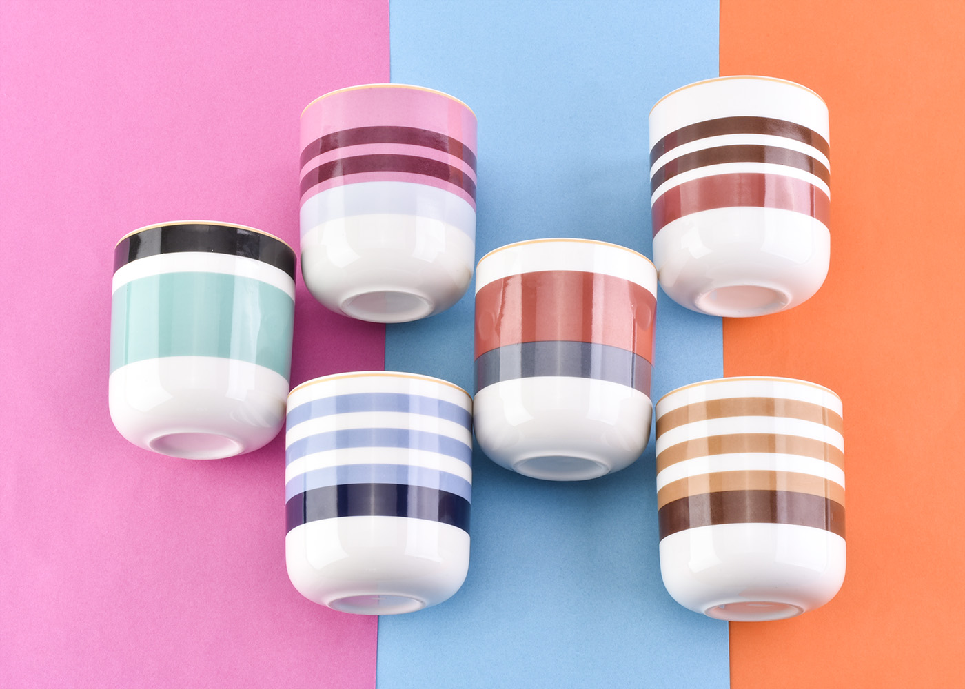 glossy ceramic candle jars with colorful stripes