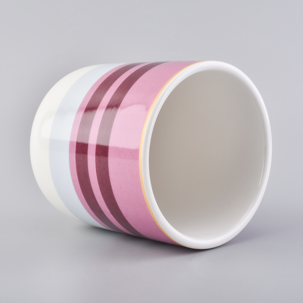 glossy ceramic candle jars with colorful stripes