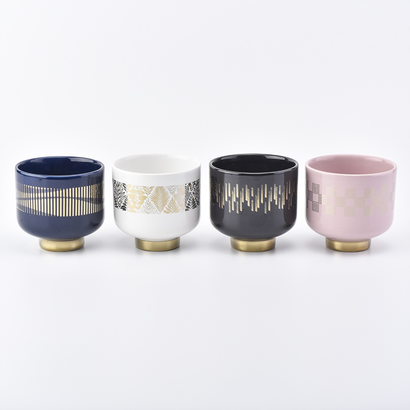 white ceramic candle jars with gold designs