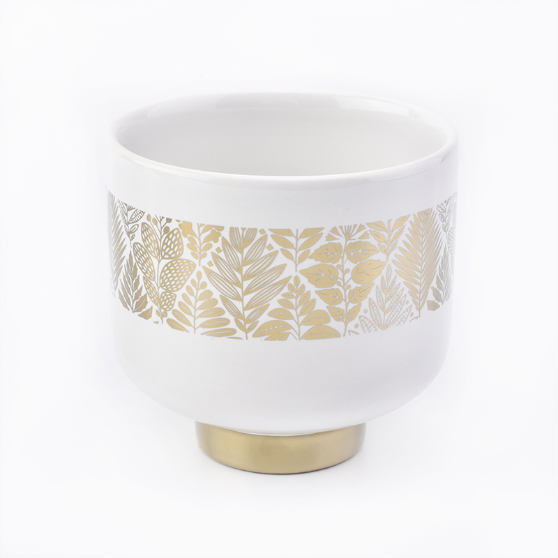 white ceramic candle jars with gold designs
