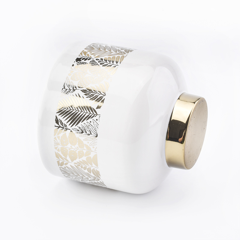 white ceramic candle jars with gold designs