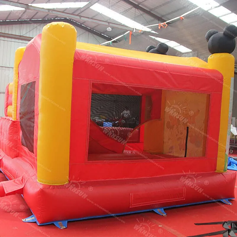 Inflatable jumping castle with slide