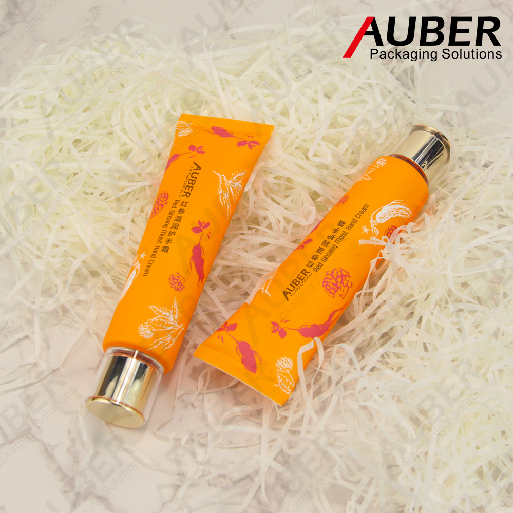 Orange colored plastic squeeze tube with acrylic cap