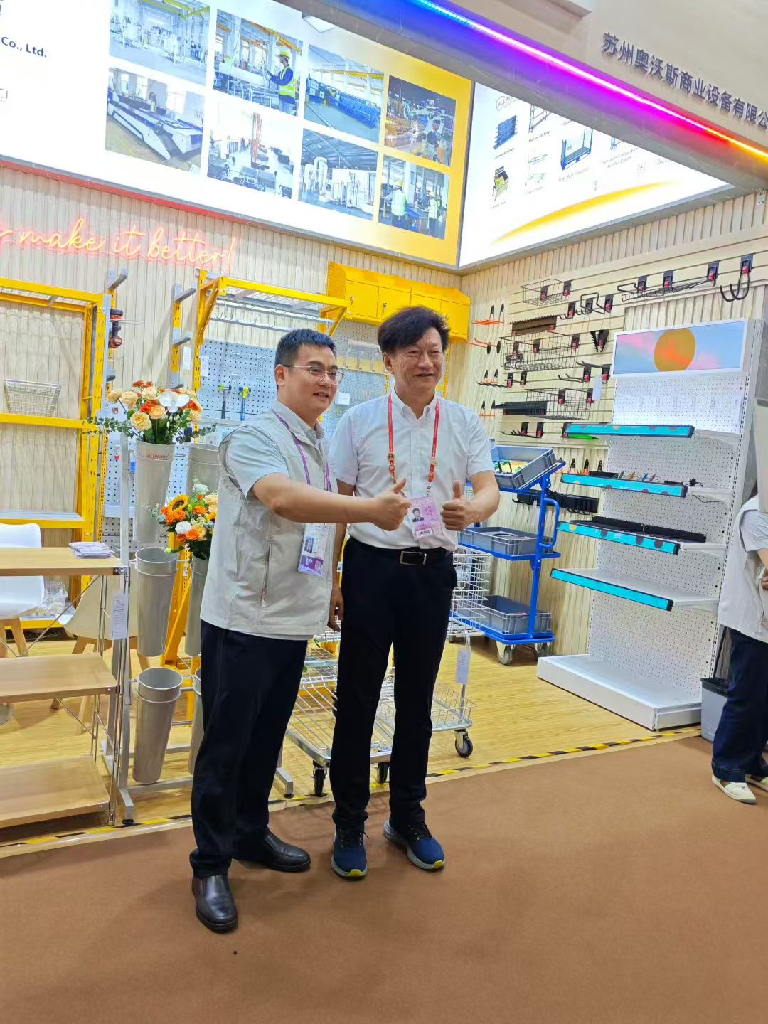ALLWORTH representative and a visiting guest give thumbs-up gestures at the company booth during the 138th Canton Fair