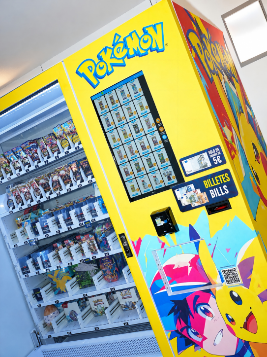 Large capacity Pokémon vending machine with elevator delivery selling TCG card packs and Pokémon toys in a Spanish shopping mall