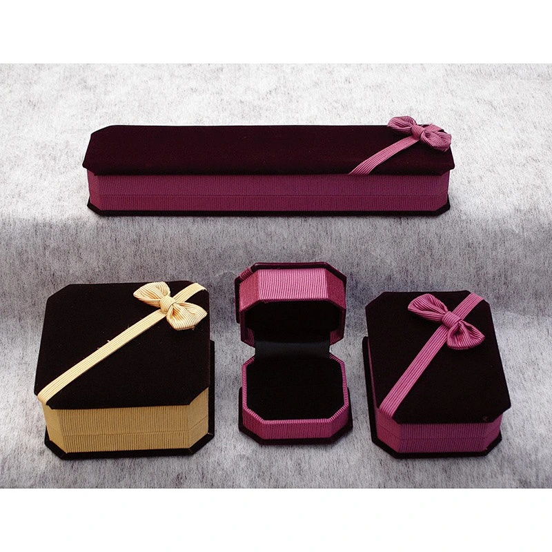 Velvet gift box in polygonal shape with bowknot on top for jewelry.