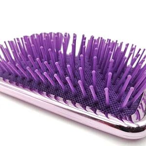 Oval detangling hair brush with elastic pins in hair extensions for long black hair