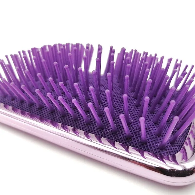 Oval detangling hair brush with elastic pins in hair extensions for long black hair