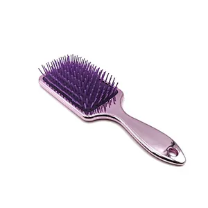 Oval detangling hair brush with elastic pins in hair extensions for long black hair