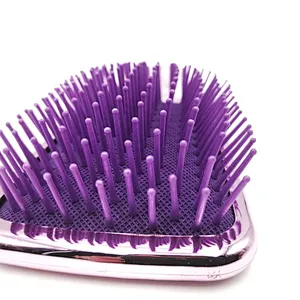 Oval detangling hair brush with elastic pins in hair extensions for long black hair