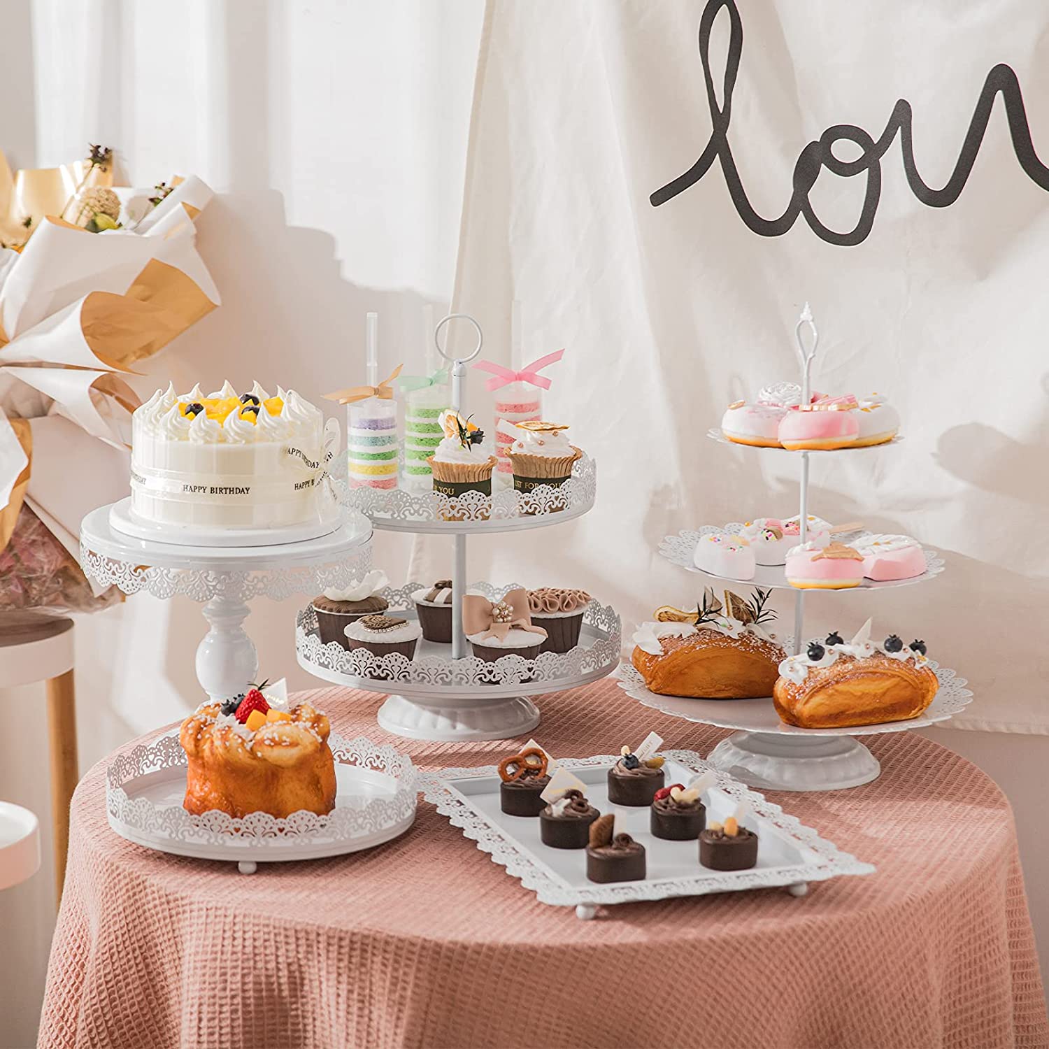 3 tier metal stand with cake in table