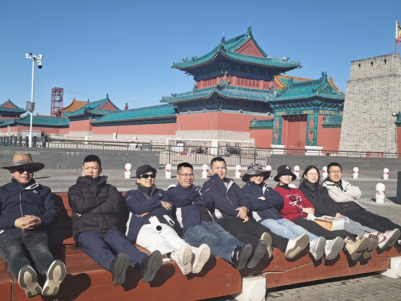 CHICO FUTURE employees enjoying a relaxing group moment in front of traditional Chinese architecture in Datong Ancient City during their team-building journey.