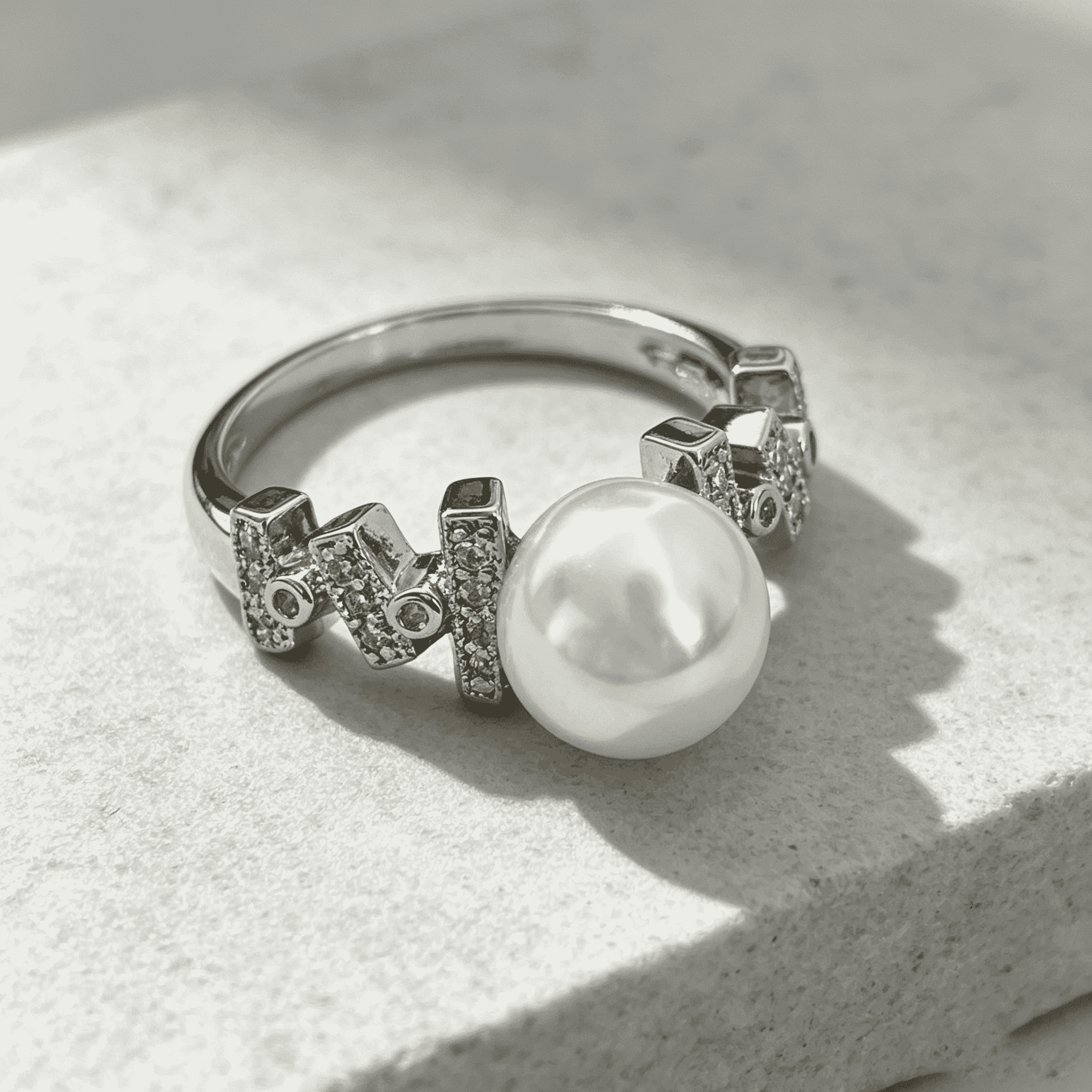 Central smooth high-luster freshwater pearl with soft creamy luster, delivers elegant feminine charm