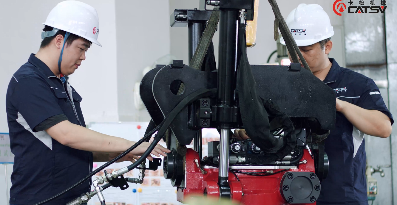 CATSU engineers inspect excavator tilt-rotator and check technical data in workshop
