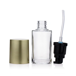 Hot sale empty  glass cosmetic 40ml transparent foundation black pump clear glass bottle with gold cap
