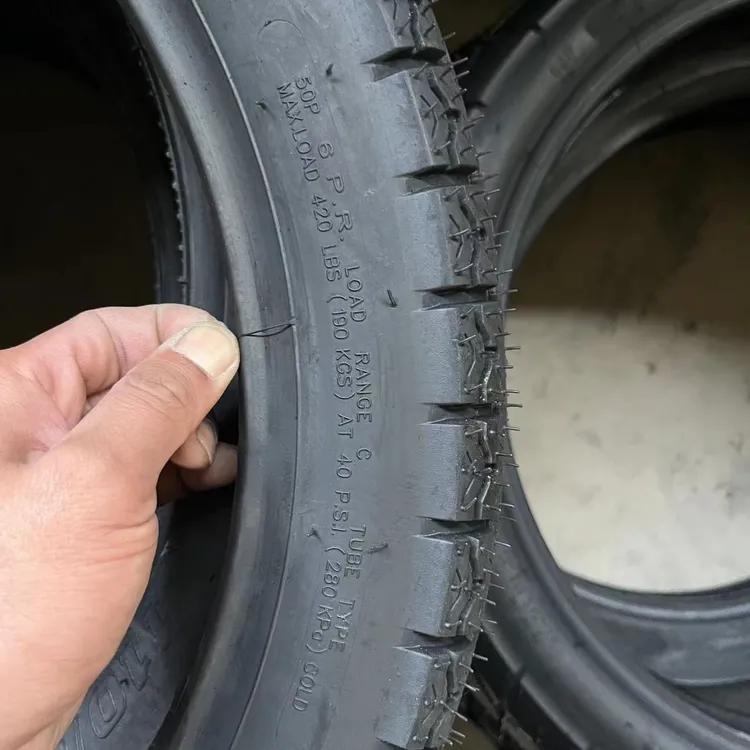 Motorcycle tire specification markings being checked during factory inspection