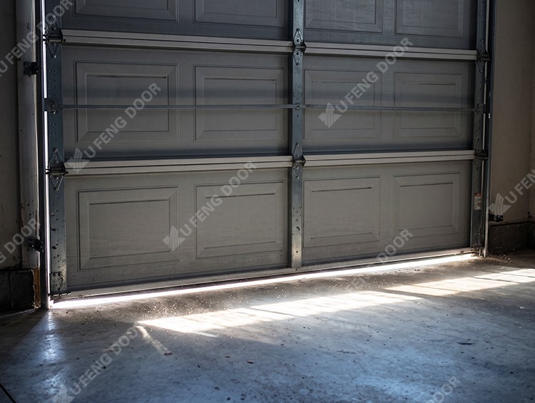 Garage door perimeter weather sealing inspection showing air draft gaps