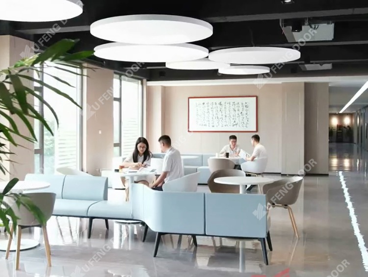 Foreign buyers discussing custom specs with an OEM industrial door supplier in a meeting room