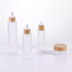 Cosmetic packaging 30ml 50ml 60ml 100ml 120ml 1oz 2oz 4oz flat shoulder clear frosted glass lotion bottle with bamboo pump cap