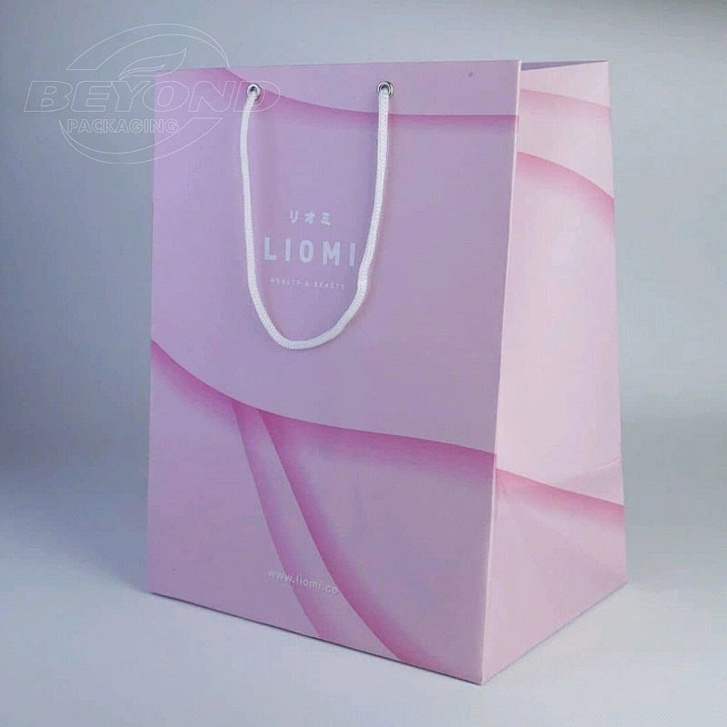 Wholesale custom logo fancy garment gift paper bag luxury small cosmetic jewelry garment gift bags for guest