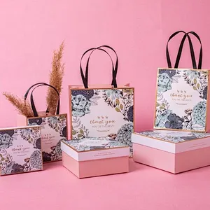 Wholesale custom logo fancy garment gift paper bag luxury small cosmetic jewelry garment gift bags for guest