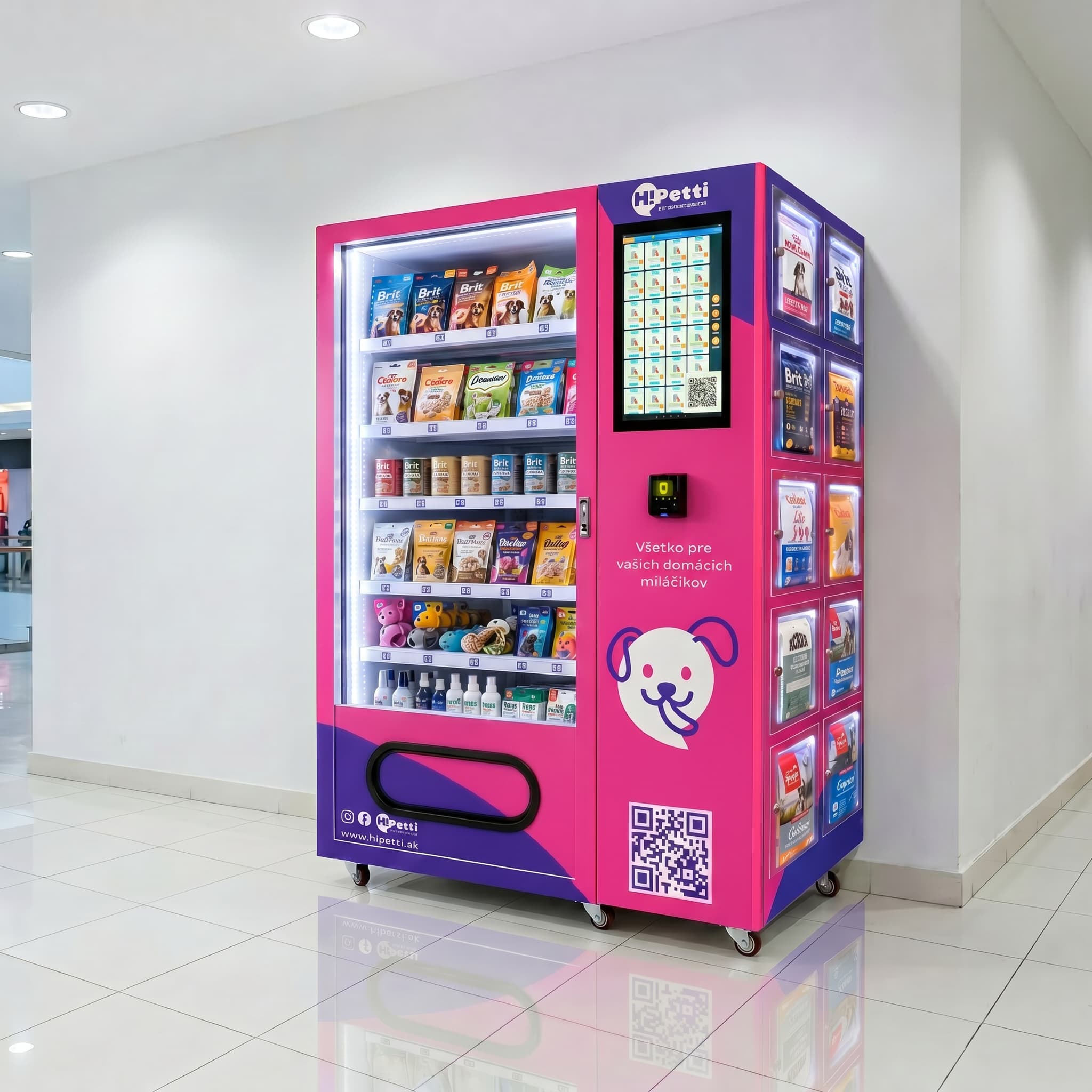 HiPetti pet supplies vending machine in pink and purple colors, side view, placed against a white wall in a modern shopping mall with bright lighting and glossy tiled floor.