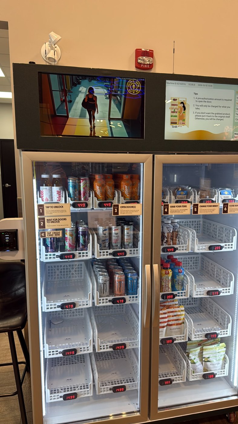 WEIMI double door gravity vending cabinet in Canada displaying drinks and packaged snacks with electronic price labels and two overhead screens