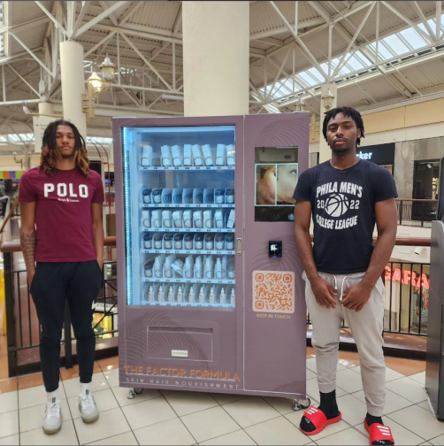 beauty vending machine placed in shopping mall and two handsome man