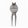 The golf divot repair tool is a small handheld device used to fix the marks or indentations made on the grass by golf clubs.