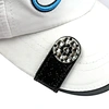 The golf ball marker hat clip is a versatile and functional accessory for golfers. It features a clip that securely attaches to a hat or visor, keeping the ball marker easily accessible.