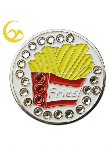 A golf marker coin is a small, round disc used to mark the position of a golf ball on the green. These coins are typically made of metal or plastic and are placed directly behind the ball.