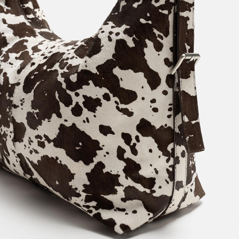 cow print crossbody bag strap detail