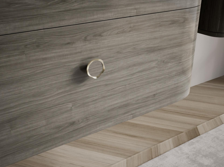 The ARIA vanity is finished with a rounded metal handle that adds a subtle touch of refinement to the curved cabinet form.
