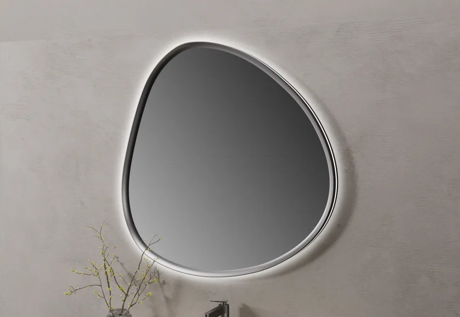 The mirror shape complements the rounded cabinet sides and helps create a more relaxed visual composition.
