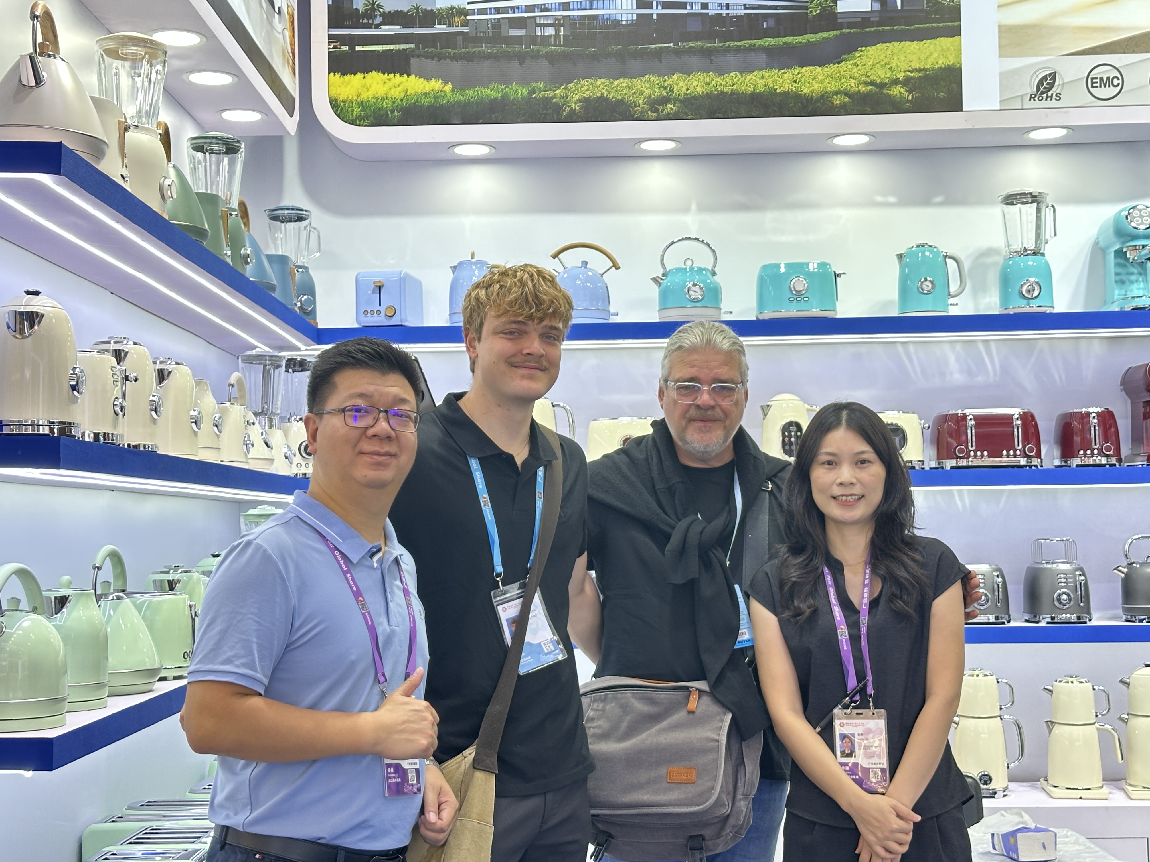 Bestone team and business visitors posing at the kitchen appliance booth