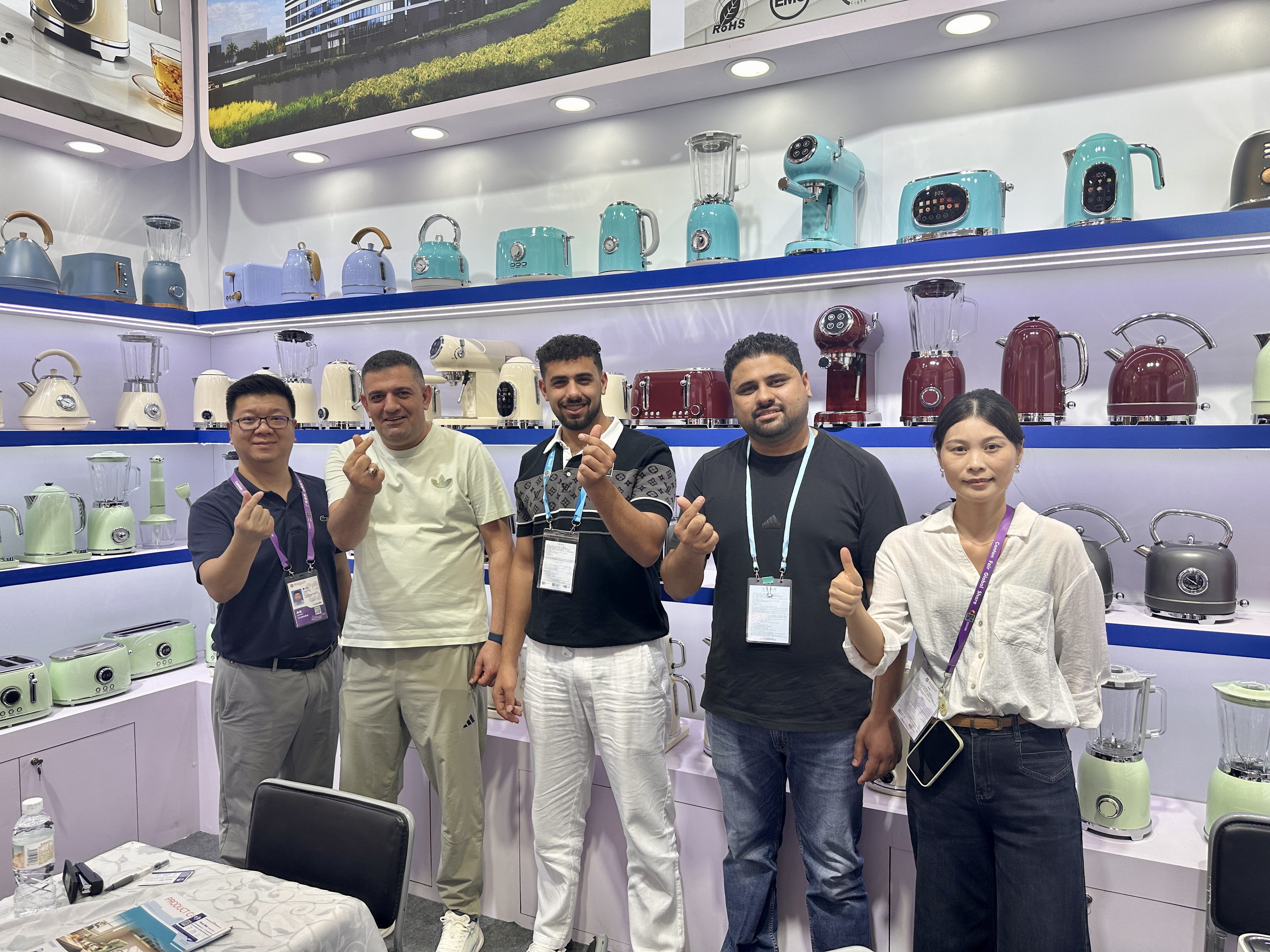 Bestone team and business visitors posing at the kitchen appliance booth