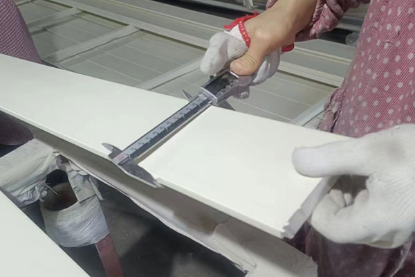 Professional QC inspects the surface of shutter components
