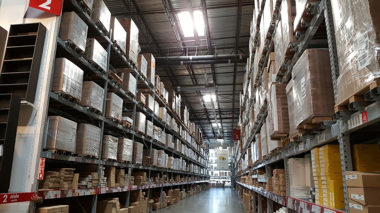 A fully operational warehouse with many paths and aisles that require a ride on floor cleaning machine