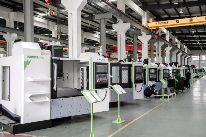 What are the characteristics of large CNC machining centers compared to ordinary machine tools