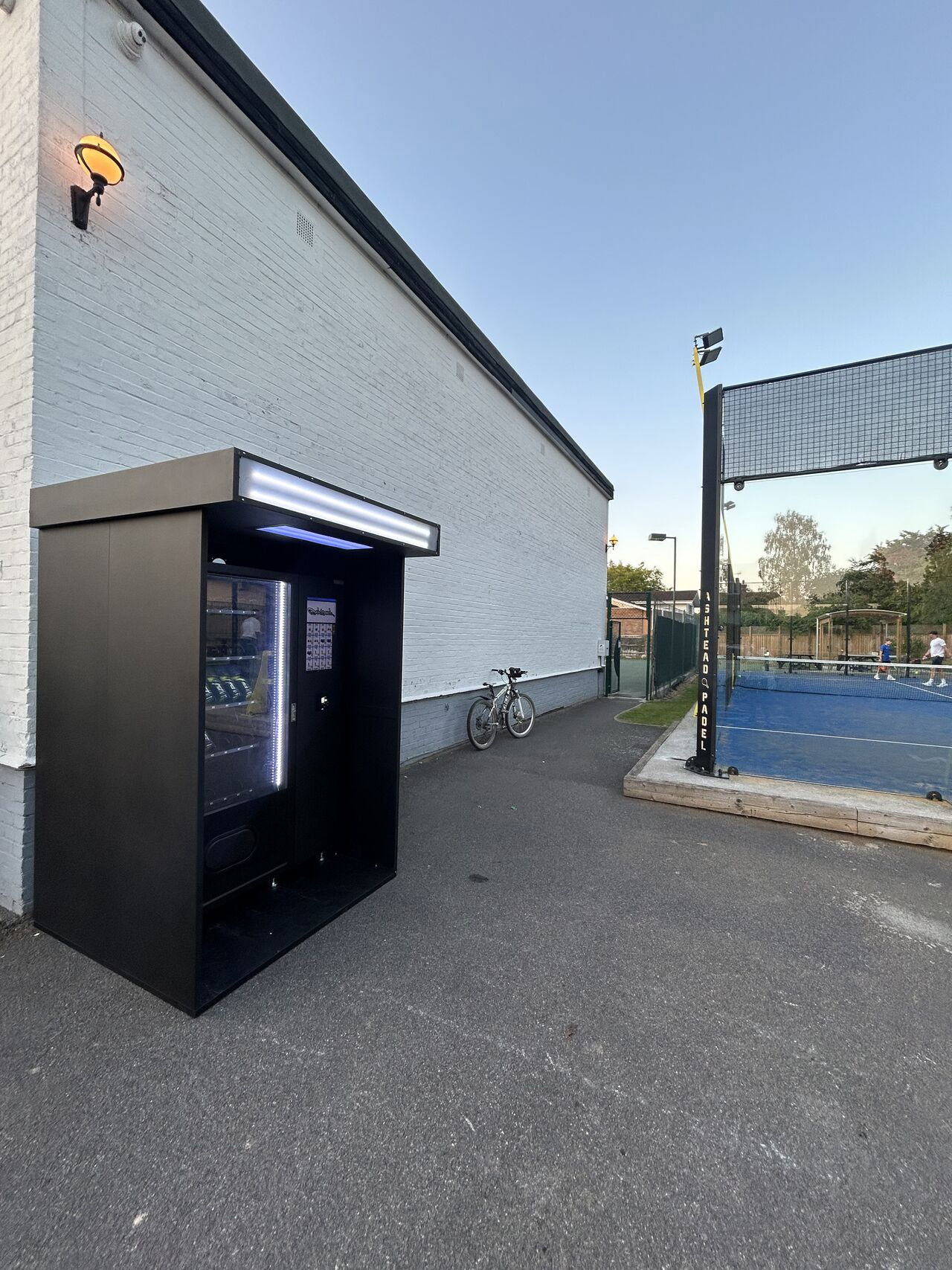 Outdoor housing for vending machine in sports venue