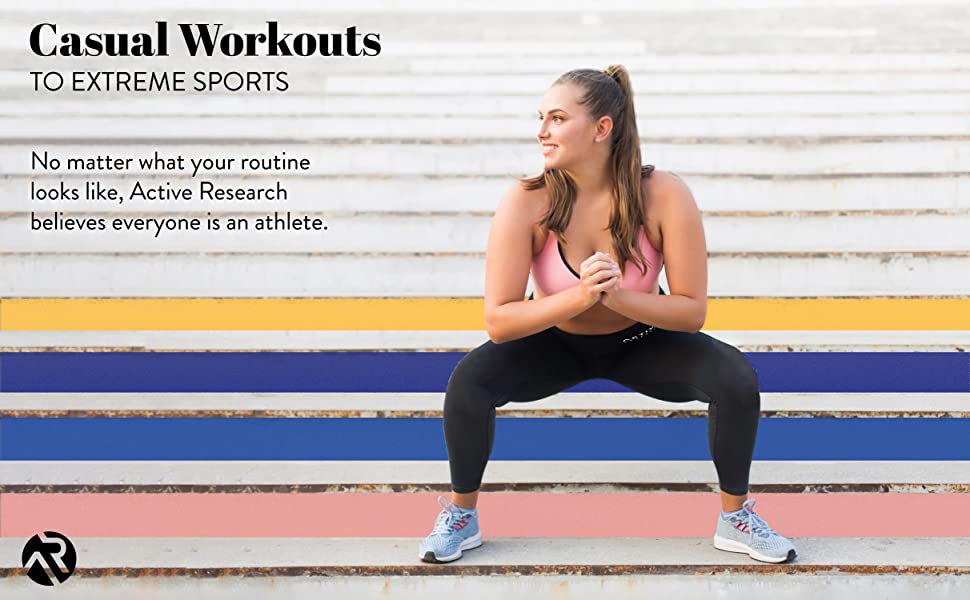 Woman squatting on steps wearing Active Research compression pants.