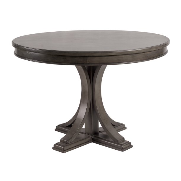 Round wood dining table in dining room