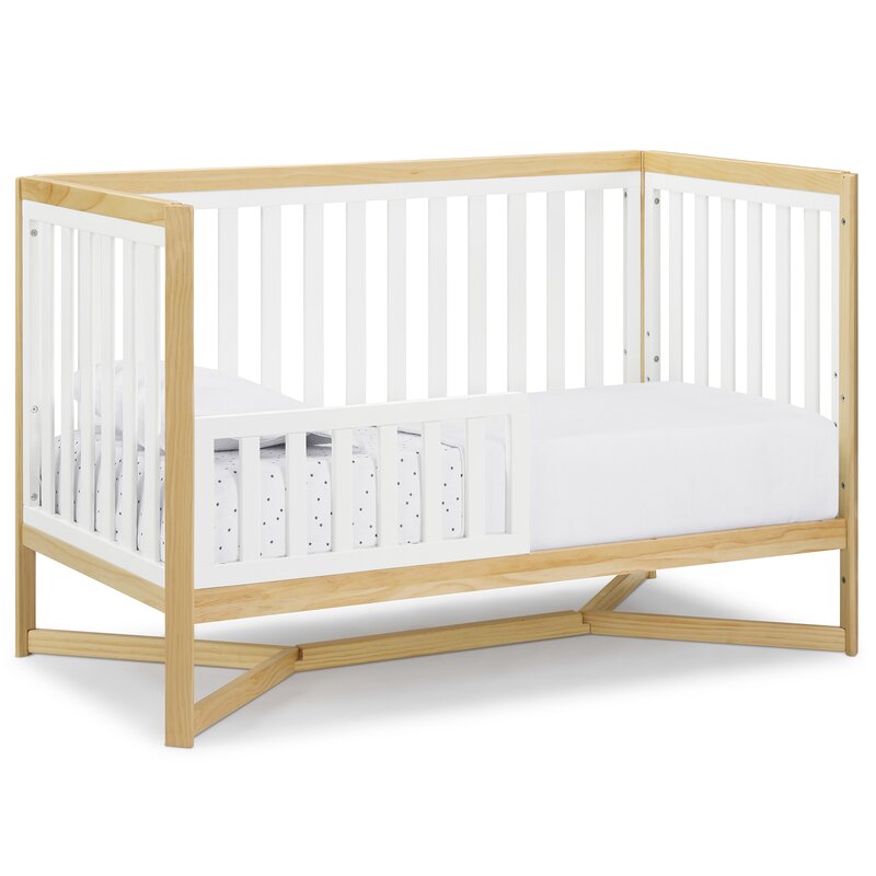 Crib side view with natural wood finish