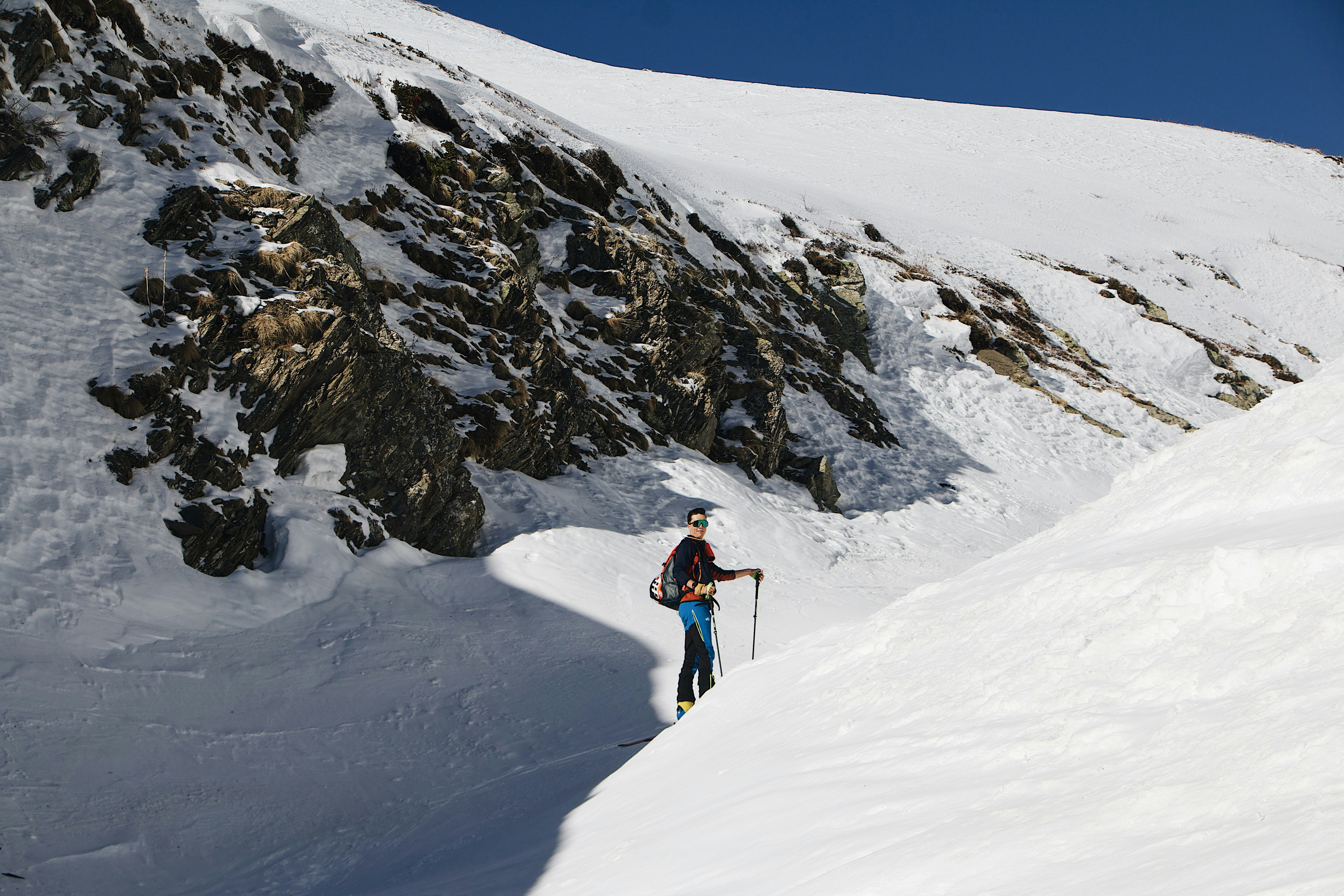 person walking on snow covered field during daytime